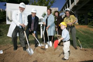 N.C. Cancer Hospital doctors, nurses and staff break ground for the new hospital with an assist from a young helper, Reece Holbrook, who was treated for leukemia at the N.C. Cancer Hospital.