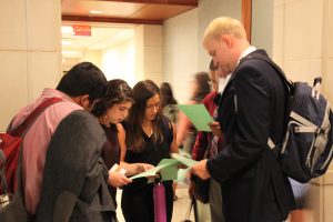 A group of students participates in a campus scavenger hunt