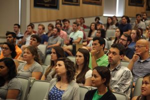 Members of the Class of 2020 listen to a presentation as a part of their orientation week